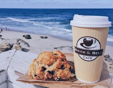 coffee and pastry from one of the top cafes in La Jolla, brick and bell, is enjoyed with a view of the beach