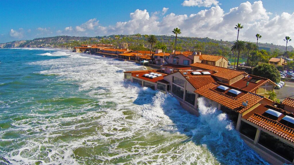 aerial view of the marine room, one of the top restaurants with a view in La Jolla. waves crash on the restaurants windows at high tide.