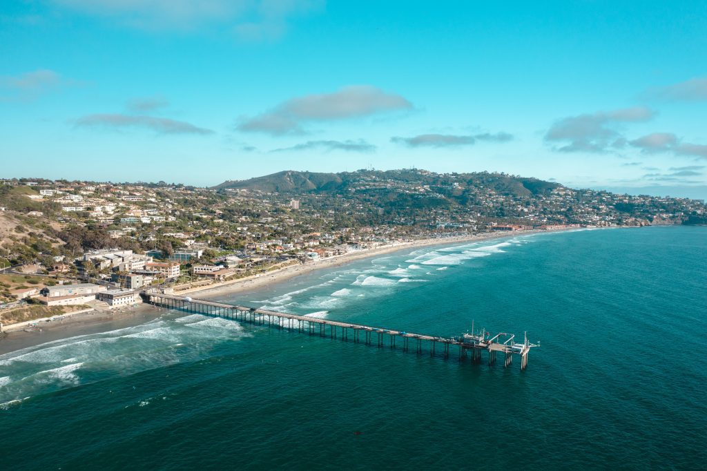 aerial view of La Jolla shores beach and Scripps Pier along the coast of La Jolla, where home prices could be affected due to climate migration