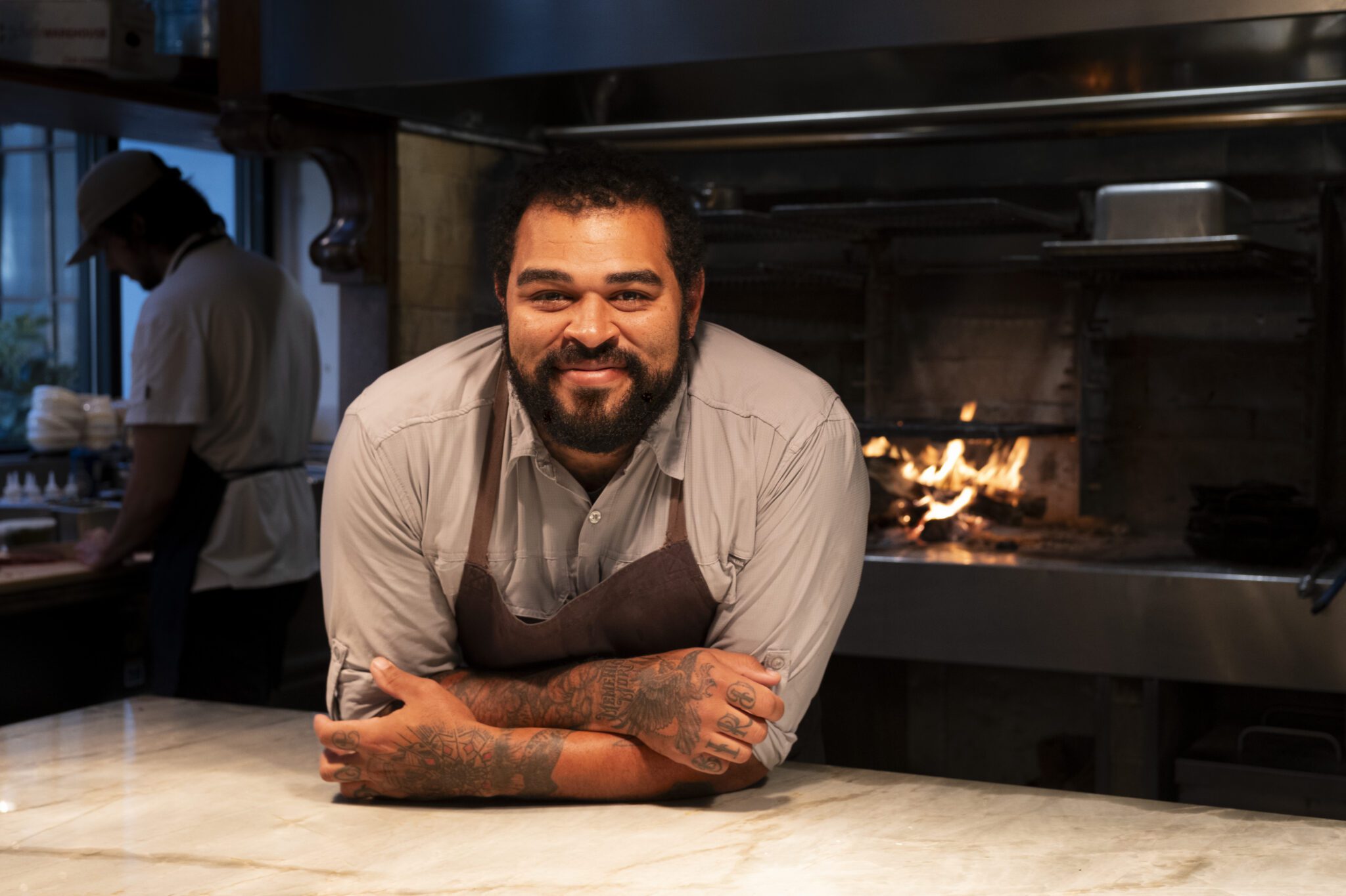 check Cameron ingle poses in kitchen at Marisi to host James beard dinner