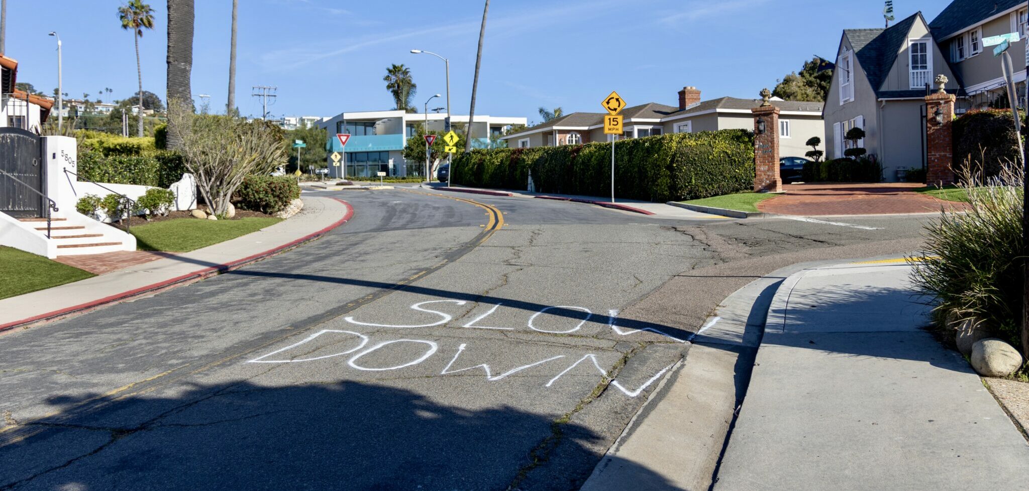 spray painted 'slow down' signs on a neighborhood street in bird rock La Jolla
