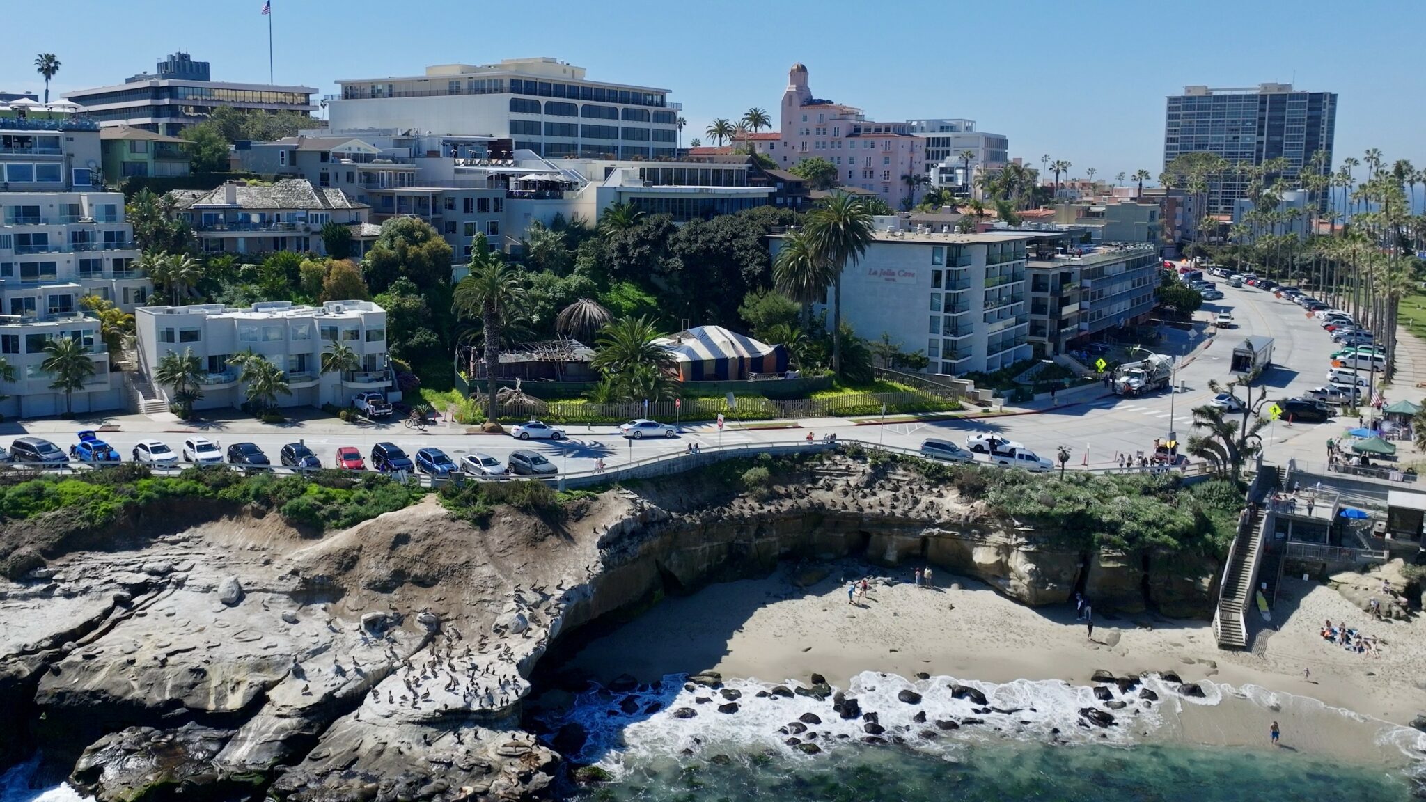 aerial overlooking old historic red rest and red roost cottages along coast of La Jolla