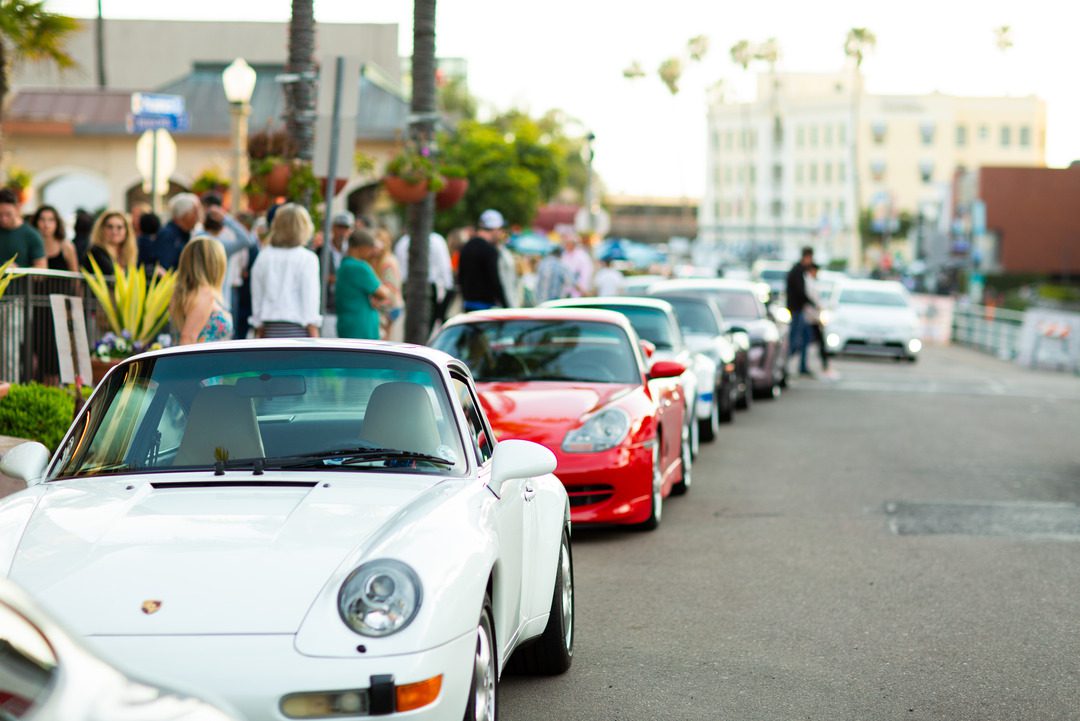 porches are parked along prospect street in La Jolla as part of the La Jolla concours d'elegance car showcase, onlookers view the cars