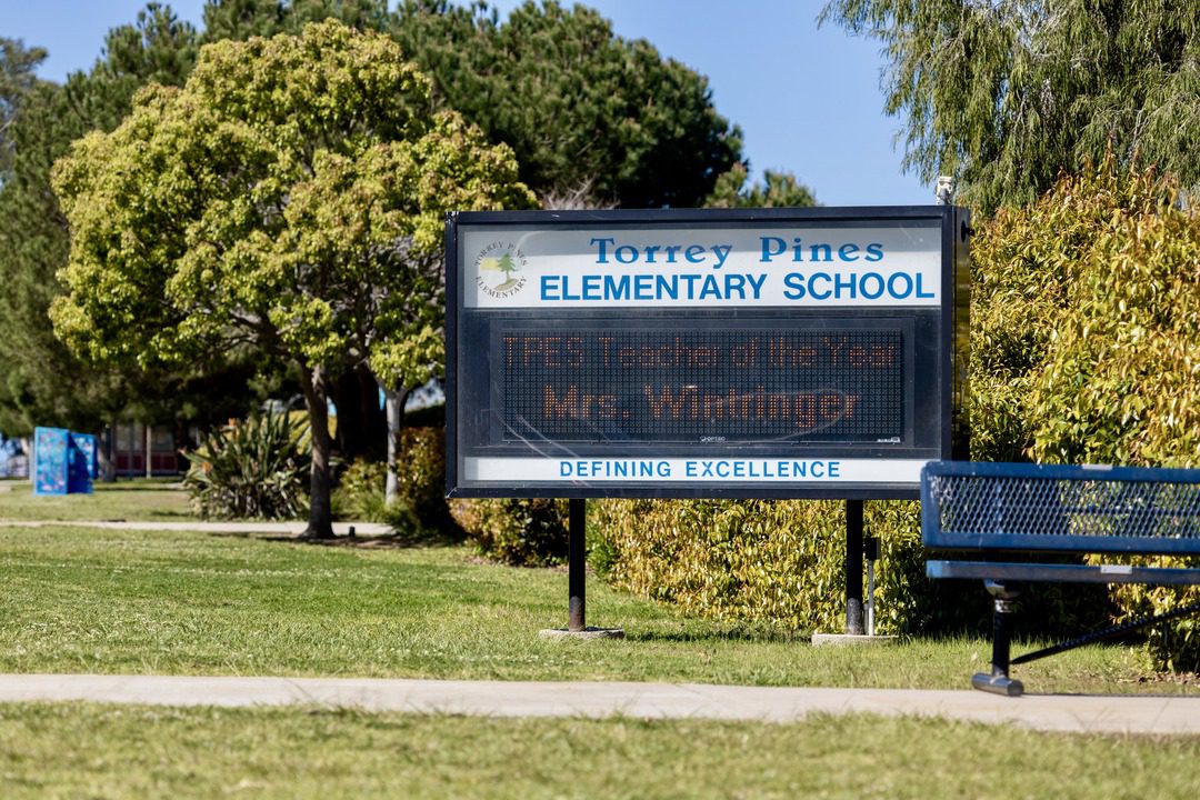 school marquee for Torrey Pines elementary school sits in front of school on grass, the marquee reads "TPES teacher of the year Mrs. Wintringer"
