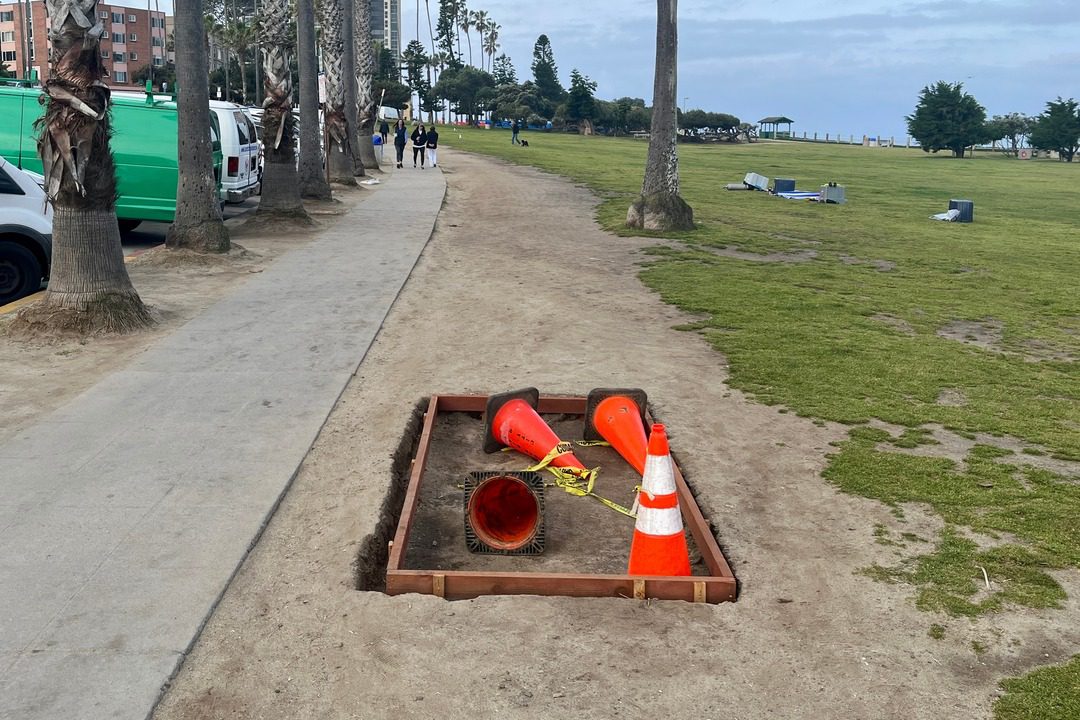 square space along scripps park sidewalk is dug out with cones inside in preparation for vendor enforcement in La Jolla