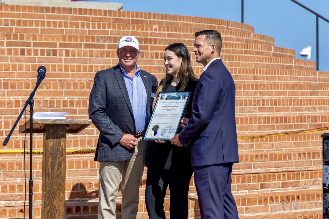 Neil O'Connell and Phil Kendro of the Mount Soledad Memorial Association (left and right) accept a proclamation from Karla Tirado.