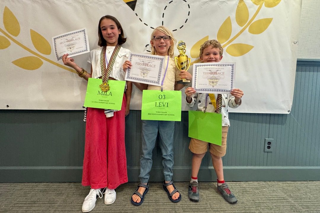 Mila Wills, Levi Pancer and Raphael Gelber show off their medals and trophy.