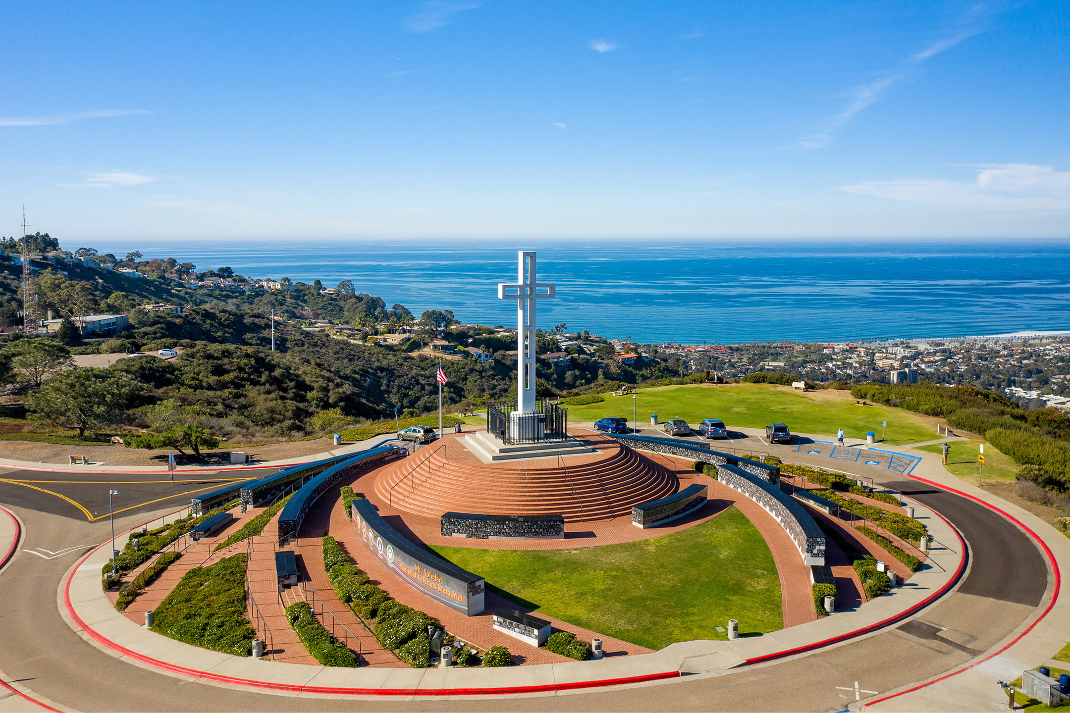 Aerial view of the Mt. Soledad Veterans Memorial cross overlooking the coastline during summer solstice in La Jolla.