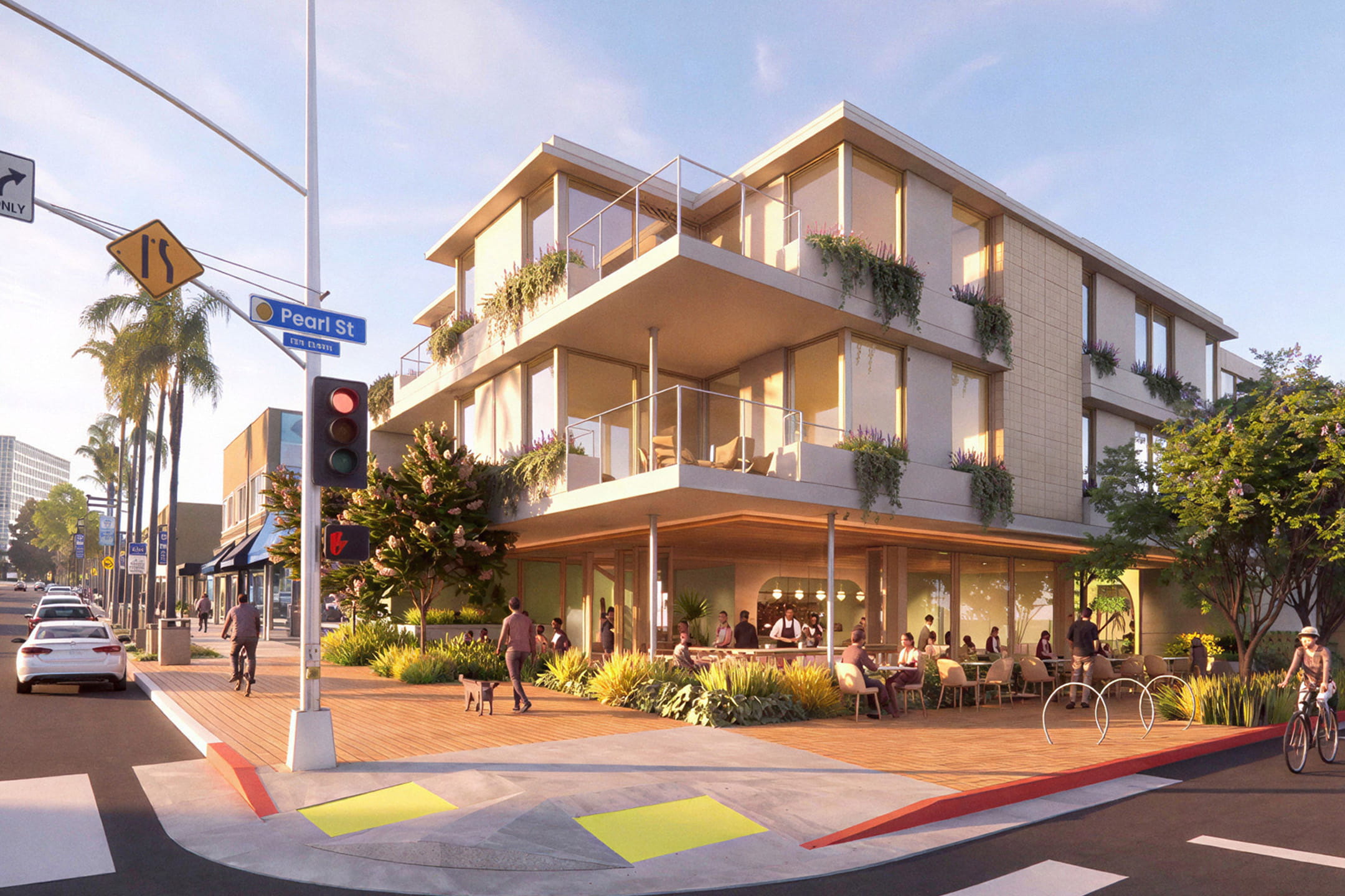 Rendering of "The Pearl," a mixed-use development in La Jolla, California, showing a three-story modern building at a street corner with wood-slat overhangs, planted balconies, and a ground-floor restaurant with outdoor seating along a wide paved plaza with bike racks and pedestrians.